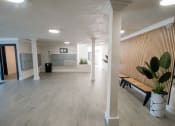 Thumbnail 12 of 22 - the lobby of a building with a wood floor and a wooden bench