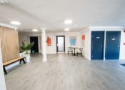Thumbnail 11 of 22 - a living room with a wood floor and blue doors