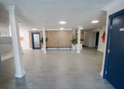 Thumbnail 13 of 22 - a large room with white pillars and a tile floor