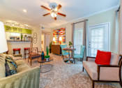 Thumbnail 12 of 14 - A living room with a ceiling fan and a couch.