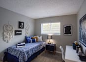 Thumbnail 28 of 32 - A bedroom with a bed, desk, and a dream catcher hanging on the wall. at The Grove Brentwood, Nashville, TN 37211 