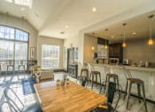 Thumbnail 18 of 23 - a dining room with a bar and a kitchen with a table and chairs at Radbourne Lake Apartments, Charlotte ?