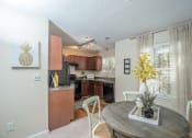 Thumbnail 5 of 23 - an open kitchen and dining room with a table and chairs at Radbourne Lake Apartments, North Carolina ?
