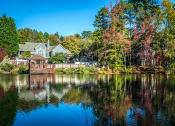 Thumbnail 10 of 23 - a view of a lake with a house in the background at Radbourne Lake Apartments, Charlotte North Carolina?
