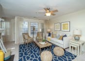 Thumbnail 9 of 23 - a living room with a ceiling fan and a white couch at Radbourne Lake Apartments, Charlotte, 28269 ?