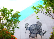 Thumbnail 6 of 22 - table with four chairs by swimming pool