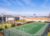 Thumbnail 16 of 20 - an outdoor basketball court with houses in the background at Keller Oaks, Carrollton, TX 75006 ?