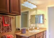 Thumbnail 14 of 20 - a bathroom with a sink and a mirror at Stone Creek at Old Farm Apartments, Houston