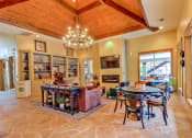 Thumbnail 3 of 20 - a dining room and living room with a table and chairs and a fireplace at Stone Creek at Old Farm Apartments, Houston, 77063
