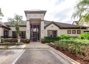 Thumbnail 5 of 20 - the front entrance of a house with a driveway and plants at Stone Creek at Old Farm Apartments, Houston, TX 77063