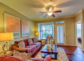 Thumbnail 13 of 20 - a living room with a ceiling fan and couches at Stone Creek at Old Farm Apartments, Houston, Texas