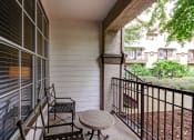 Thumbnail 10 of 20 - a balcony with a table and two chairs on it at Stone Creek at Old Farm Apartments, Texas 77063