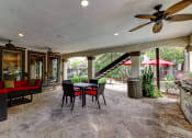 Thumbnail 16 of 20 - a patio with a table and chairs and a spiral staircase at Stone Creek at Old Farm Apartments, Texas 77063