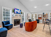 Thumbnail 9 of 27 - a living room with a fireplace and a tv above it