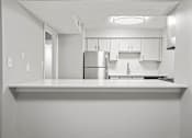 Thumbnail 15 of 27 - a kitchen with a counter top and a refrigerator
