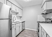 Thumbnail 13 of 27 - a kitchen with white cabinets and stainless steel appliances