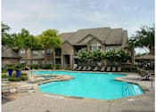 Thumbnail 13 of 14 - A large house with a pool in front.