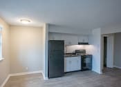 Thumbnail 26 of 32 - a kitchen with white cabinets and a black refrigerator
