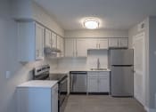 Thumbnail 19 of 32 - renovated kitchen with white cabinets and stainless steel appliances