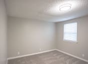 Thumbnail 29 of 32 - a bedroom with carpet and a window