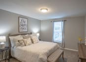 Thumbnail 20 of 32 - a bedroom with a bed and a window