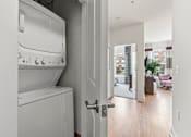 Thumbnail 34 of 57 - A white washing machine and dryer in a laundry room.