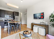 Thumbnail 27 of 57 - A modern kitchen with a dining table and chairs.