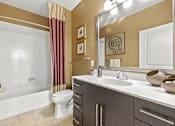 Thumbnail 24 of 57 - A bathroom with a white tub, toilet, and sink.