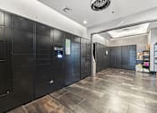 Thumbnail 22 of 57 - A hallway with black lockers and a wooden floor.