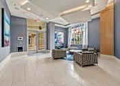 Thumbnail 21 of 57 - A spacious lobby with a fireplace and a large painting on the wall.