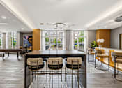 Thumbnail 56 of 57 - A modern kitchen with a bar area and seating.