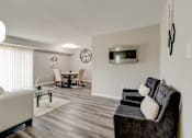 Thumbnail 1 of 11 - A living room with a grey couch and a white sofa.