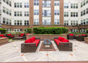 Thumbnail 43 of 57 - A courtyard with red couches and a fountain in the middle.