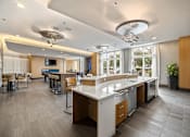 Thumbnail 54 of 57 - A modern kitchen with a large island and a dining area.