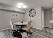 Thumbnail 4 of 11 - A dining room with a round table and chairs.