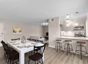 Thumbnail 7 of 12 - A dining room with a white table and chairs.