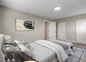 Thumbnail 8 of 12 - A bedroom with a large bed and a painting on the wall.