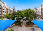 Thumbnail 48 of 57 - A courtyard with a blue tarp covering the ground.