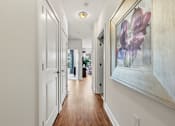 Thumbnail 38 of 57 - A long hallway with a painting on the wall.