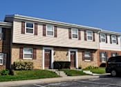 Thumbnail 31 of 33 - A row of houses with brown and beige siding.