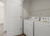 Thumbnail 53 of 57 - A white door is open to a laundry room with two washing machines.