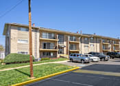 Thumbnail 20 of 35 - A parking lot in front of apartment buildings.