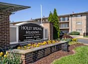 Thumbnail 25 of 35 - Holly Spring Meadows is apartment complex with a sign in front.