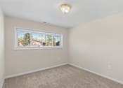 Thumbnail 31 of 35 - A room with a window and a carpeted floor.
