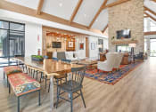 Thumbnail 23 of 43 - a living room with a wooden table and a fireplace