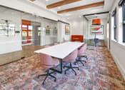 Thumbnail 21 of 43 - a conference room with a white table and chairs