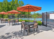 Thumbnail 34 of 43 - our patio has tables and chairs with umbrellas and a pool in the background