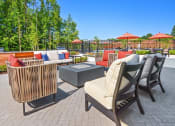 Thumbnail 29 of 43 - a patio with chairs and tables and umbrellas