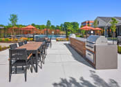 Thumbnail 32 of 43 - the reserve at city center clubhouse patio with grill and dining table