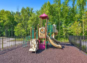 Thumbnail 33 of 43 - a playground with a swing set and slides in a park